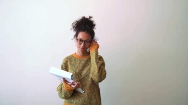Cheerful Woman Wearing Yellow Sweater Looking Camera Holding Document Isolated — Stock Video