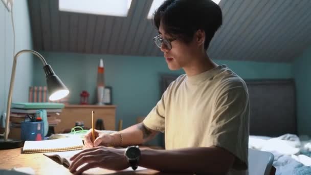 Concentrated Asian Boy Learns English Writes His Notebook Home Evening — Stockvideo
