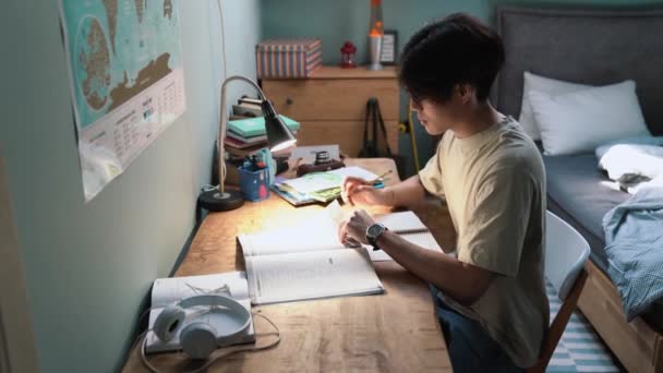 Serious Asian Man Learns English Writes His Notepad Home Evening — Stockvideo