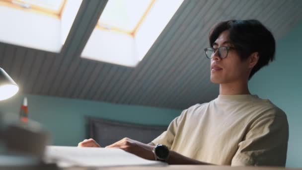 Confident Asian Man Writes His Notebook Home Evening — Video Stock