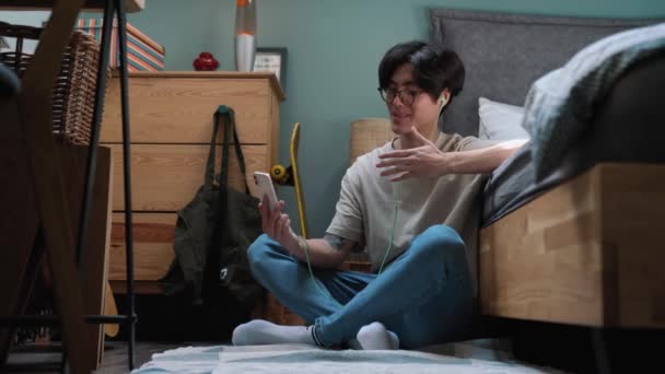 Cheerful Asian Man Talking Video Call Smartphone While Sitting Floor — Video