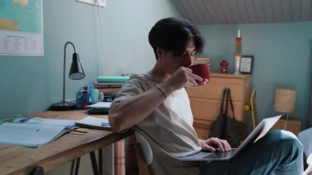 Concentrated Asian Man Wearing Shirt Working Laptop Drinking Coffee Home — Video Stock