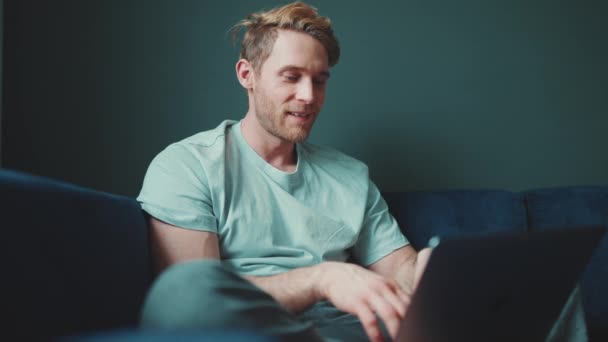 Positive Blond Athletic Man Working Laptop Looking Side While Sitting — Stock Video