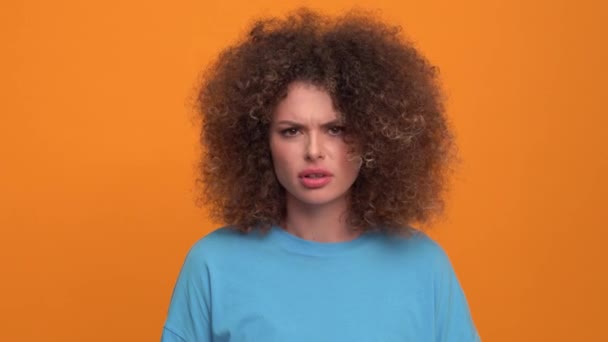 Displeased Curly Haired Blonde Woman Wearing Blue Shirt Disagrees Something — Stockvideo