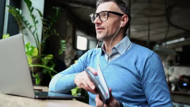 Positive Grey Haired Man Working Laptop Drinking Coffee While Sitting — Vídeo de stock