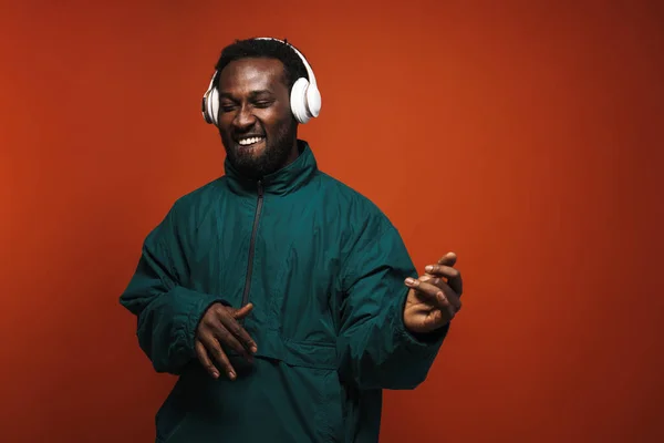 Black Bristle Man Dancing While Listening Music Headphones Isolated Brown — Stockfoto