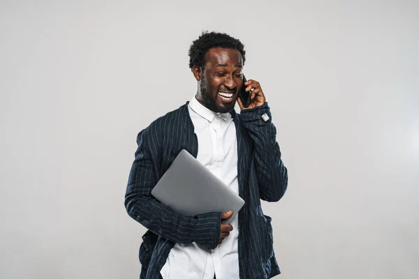 Young Black Man Talking Cellphone While Posing Laptop Isolated White — Stock Photo, Image