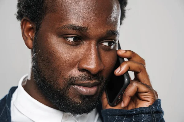 Egy Fiatal Fekete Férfi Félrenéz Miközben Telefonál Elszigetelve Fehér Faltól — Stock Fotó