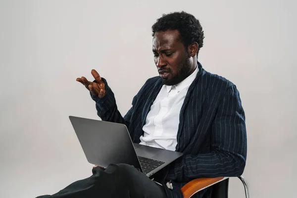 Young Black Man Working Laptop While Sitting Chair Isolated White — Stock Photo, Image