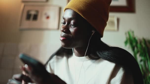 Positive African Young Woman Wearing White Sweater Drinking Coffee Listening — Wideo stockowe