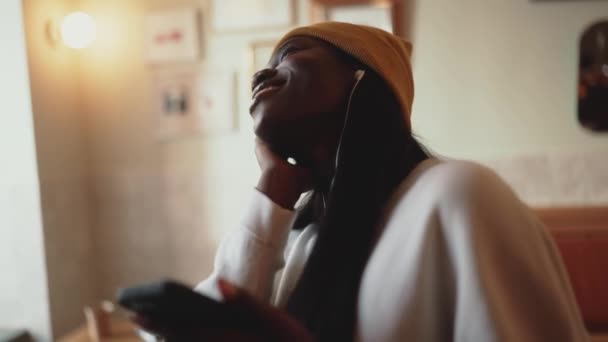 Cheerful African Young Woman Wearing White Sweater Listening Music Headphones — Wideo stockowe