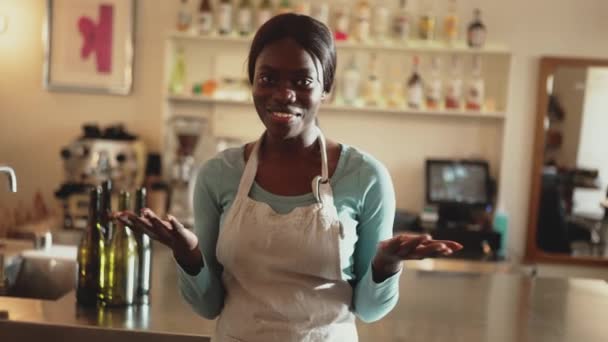 Smiling African Woman Barista Wearing White Apron Talking Camera Cafe — Αρχείο Βίντεο