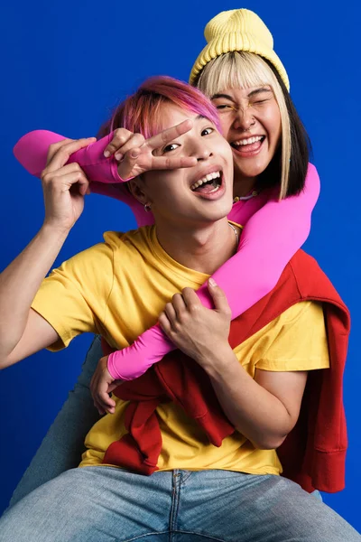 Asian Couple Multicolored Hair Hugging While Showing Piece Sign Isolated — Fotografia de Stock