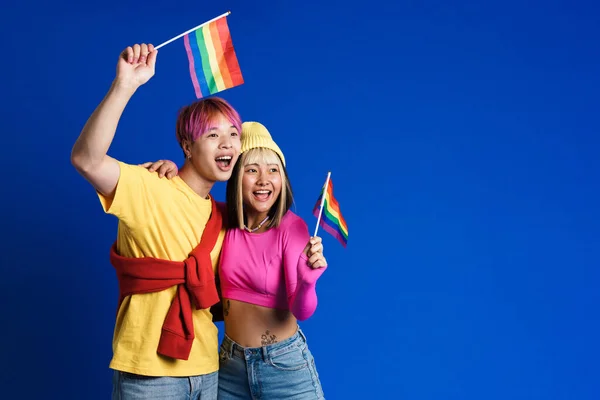 Asian Teenagers Laughing Hugging While Posing Rainbow Flags Isolated Blue — Stockfoto