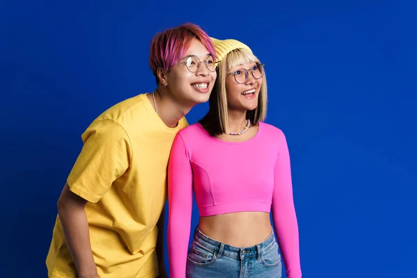 Asian Teenagers Eyeglasses Laughing Looking Aside Isolated Blue Wall — Stockfoto