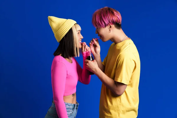 Asian Couple Multicolored Hair Laughing While Drinking Soda Isolated Blue — Fotografia de Stock