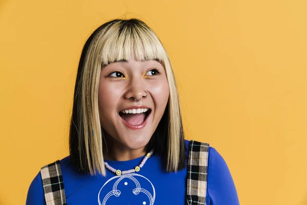 Asian Girl Piercing Laughing Looking Aside Isolated Yellow Wall — Stockfoto