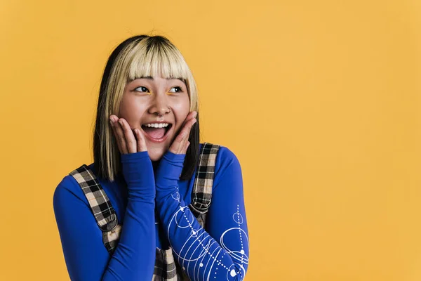 Asian Girl Piercing Laughing Looking Aside Isolated Yellow Wall — Fotografia de Stock