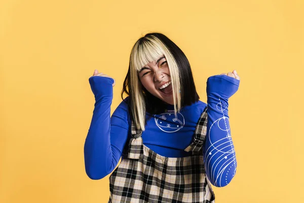 Asian Girl Piercing Screaming While Making Winner Gesture Isolated Yellow — Foto Stock