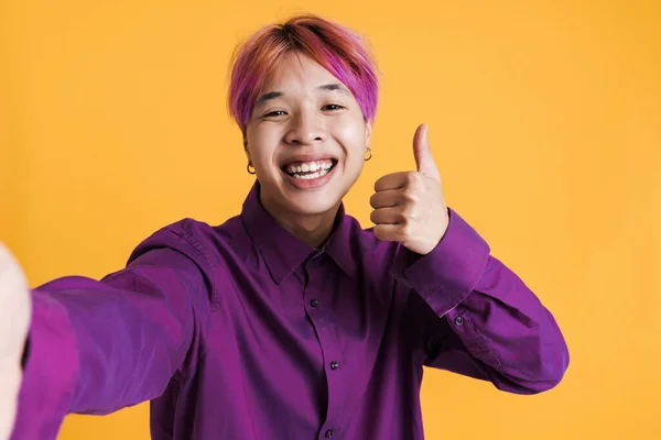 Asian Boy Showing Thumb While Taking Selfie Photo Isolated Yellow — Stok fotoğraf