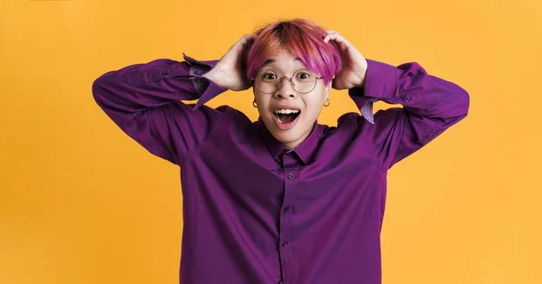 Asian Boy Holding His Head While Expressing Surprise Isolated Yellow — 스톡 사진