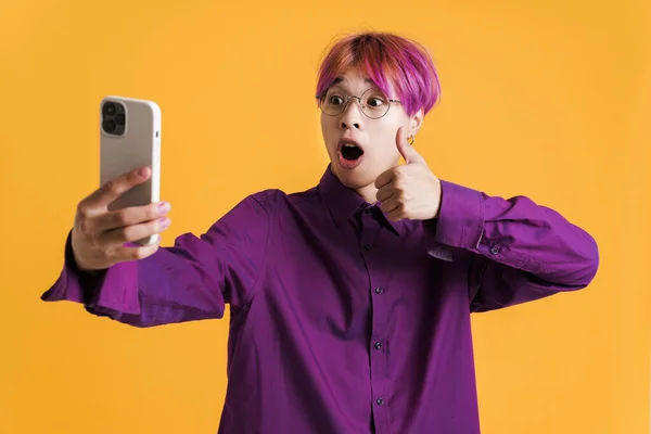 Asian Boy Showing Thumb Taking Selfie Photo Cellphone Isolated Yellow — 图库照片