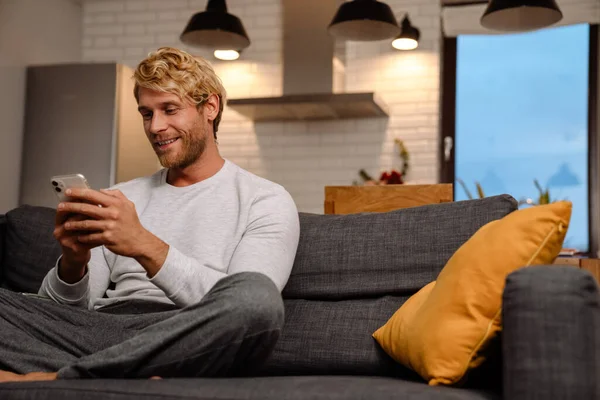 Ginger Bristle Man Using Mobile Phone While Sitting Sofa Home — Foto de Stock