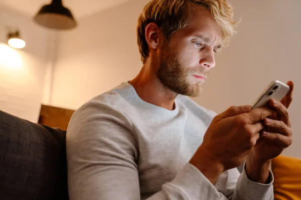 Ginger Bristle Man Using Mobile Phone While Sitting Sofa Home — Stock Fotó