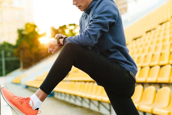 Young White Runner Using Smartwatch While Working Out Stadium Outdoors — 스톡 사진