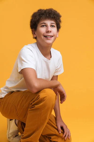 White Curly Boy Wearing Suit Smiling While Crouching Isolated Yellow — Stockfoto