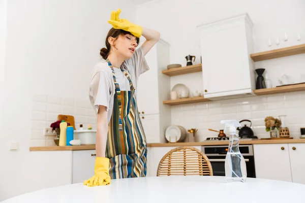 White Young Woman Gloves Wiping Her Forehead While Cleaning Table — Stock Photo, Image