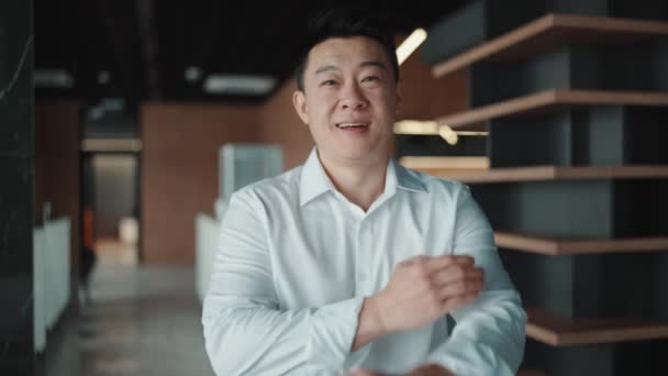 Cheerful Asian Brunet Businessman Looking Camera Holding Hands Office — стоковое видео