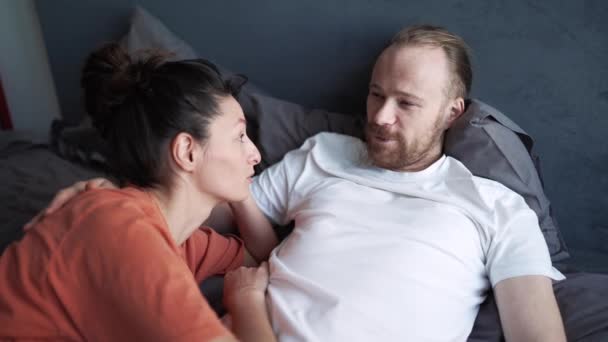 Positive Couple Talking While Lying Bed Home — Stockvideo