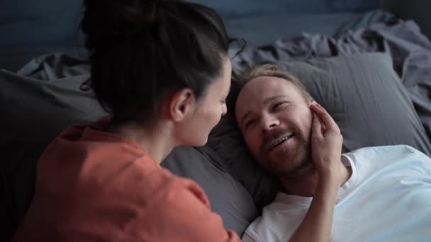 Pleased Couple Kissing While Lying Bed Home — Vídeo de stock