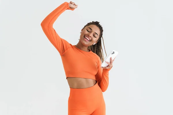 Black Young Sportswoman Using Smartphone Earphones Isolated White Background — Stockfoto