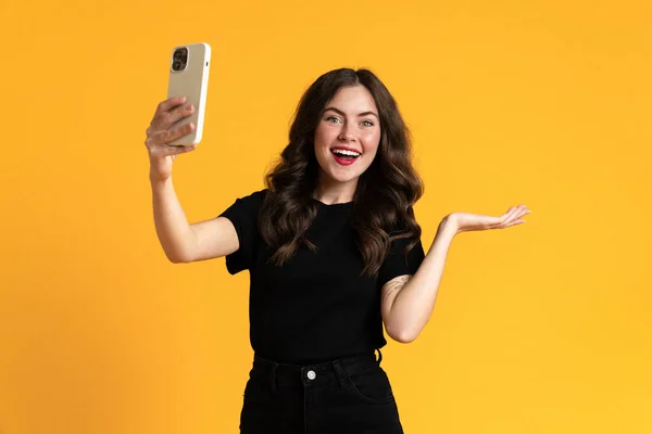 White Woman Holding Copyspace While Taking Selfie Cellphone Isolated Yellow — 스톡 사진