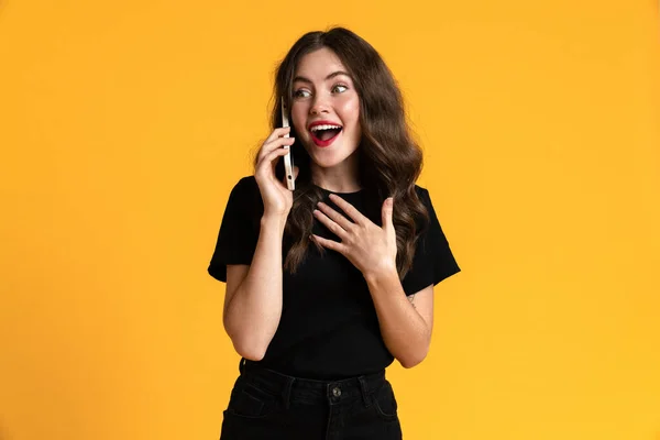 White Excite Woman Gesturing While Talking Mobile Phone Isolated Yellow — стоковое фото