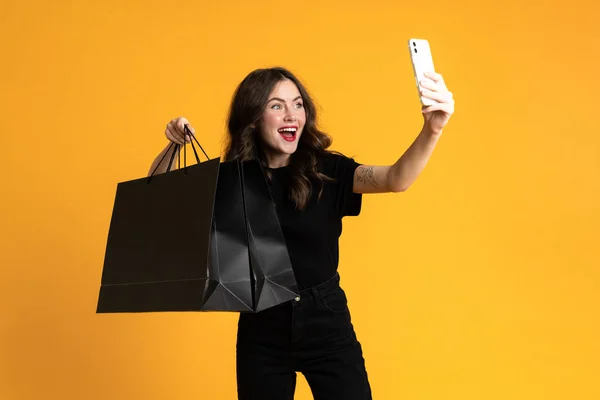 White Excited Woman Taking Selfie Shopping Bags Isolated Yellow Background — Stock Fotó