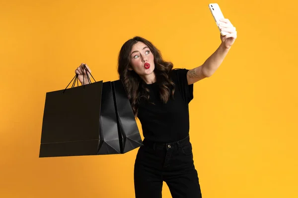 White Young Woman Taking Selfie Shopping Bags Isolated Yellow Background — Stock Fotó