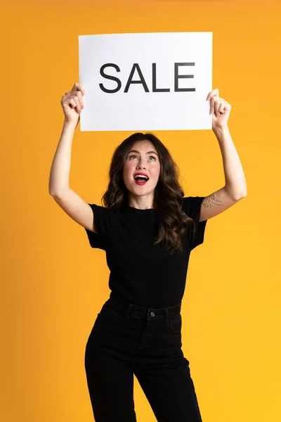 White Young Woman Looking Upward While Posing Sale Placard Isolated — 图库照片