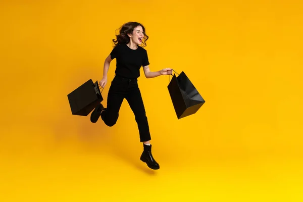 White Excited Woman Laughing While Running Shopping Bags Isolated Yellow — Foto de Stock