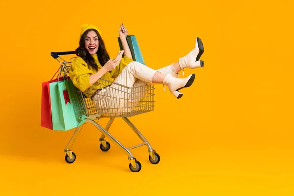 White Excited Woman Laughing Using Cellphone Shopping Cart Isolated Yellow — Φωτογραφία Αρχείου