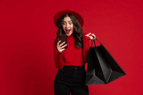 White Woman Laughing While Posing Shopping Bags Cellphone Isolated Red — Stockfoto