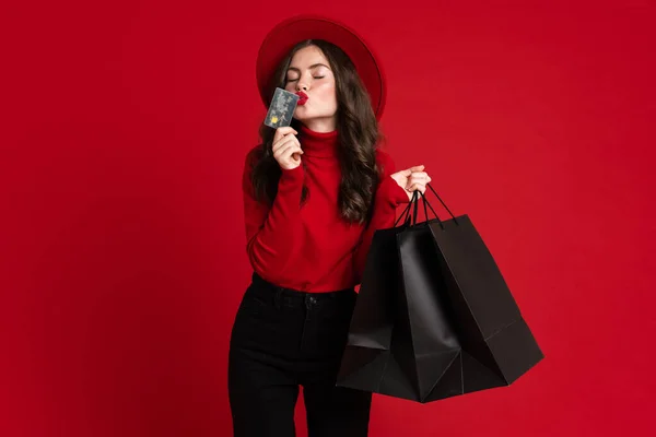 White Woman Kissing Credit Card While Posing Shopping Bags Isolated — Stock Fotó