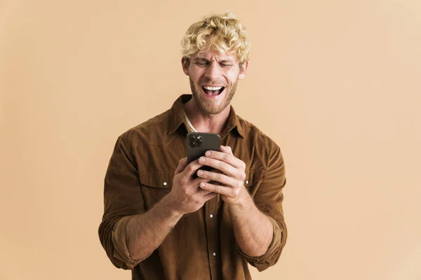 White Blonde Man Wearing Shirt Laughing Using Cellphone Isolated Beige — Foto de Stock