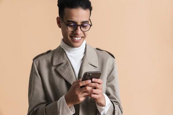 Young Middle Eastern Man Eyeglasses Using Mobile Phone Isolated Beige — Stockfoto