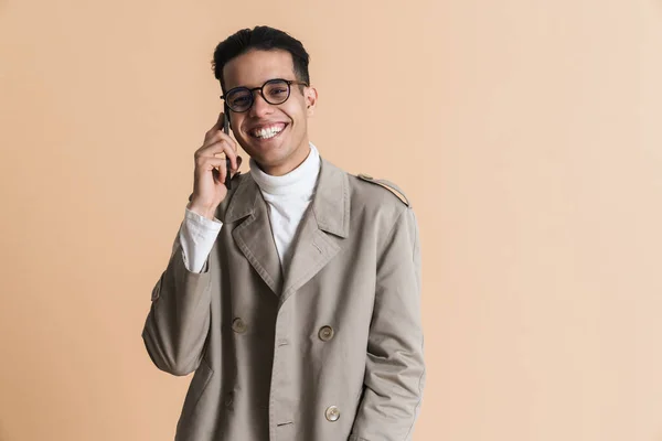 Young Middle Eastern Man Eyeglasses Talking Mobile Phone Isolated Beige — 图库照片