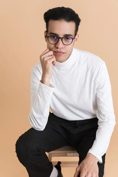 Young Middle Eastern Man Looking Camera While Sitting Chair Isolated — 图库照片