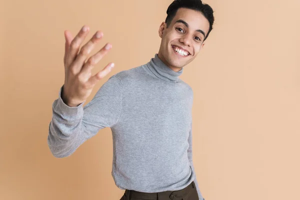 Young Middle Eastern Man Gesturing Smiling Camera Isolated Beige Background — 图库照片