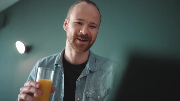 Smiling Blond Man Drinking Orange Juice Looking Tablet Morning Home — Stock Video